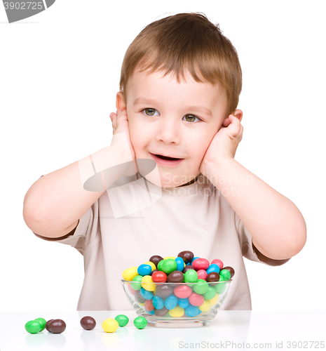 Image of Portrait of a boy with candies