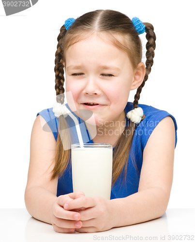 Image of Sad little girl with a glass of milk