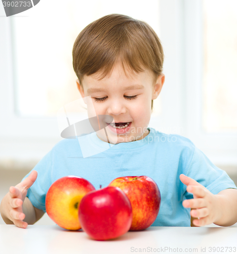 Image of Portrait of a happy little boy with apples