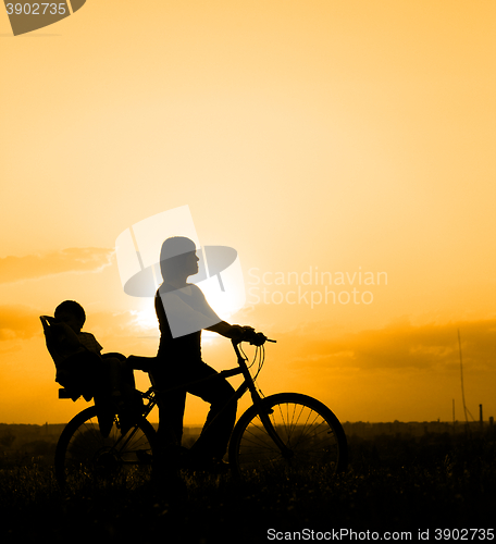 Image of Mother riding on a bicycle with her child