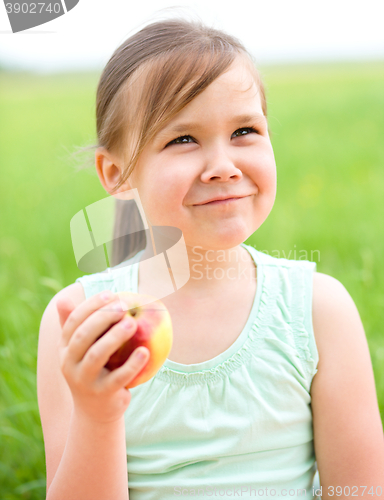 Image of Portrait of a little girl with apple