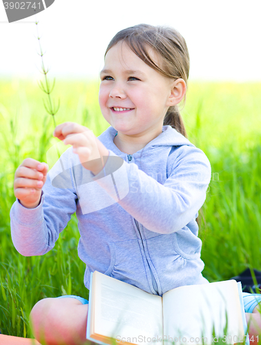 Image of Little girl is studying plants