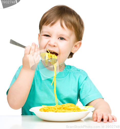 Image of Little boy is eating spaghetti