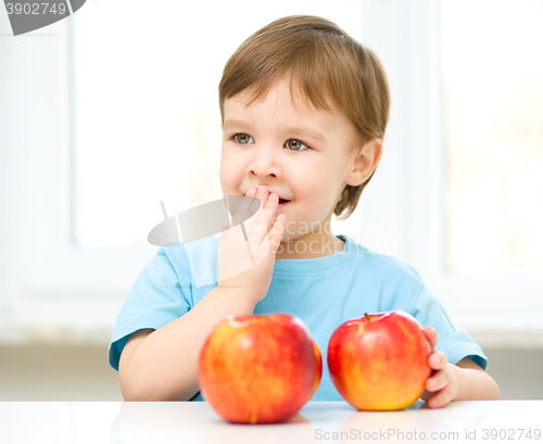 Image of Portrait of a happy little boy with apples