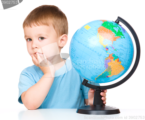 Image of Little boy with a globe