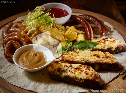 Image of Assorted fried sausages, grilled potatoes, sauce Adjika, Mustard Sauce