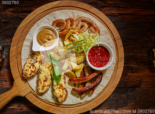 Image of Assorted fried sausages, grilled potatoes, sauce Adjika, Mustard Sauce