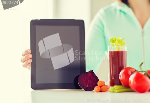 Image of close up of woman with tablet pc and vegetables
