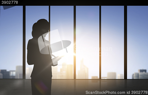 Image of silhouette of business woman with tablet pc