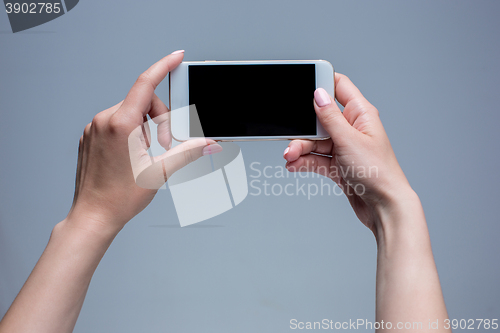 Image of Closeup shot of a woman typing on mobile phone 