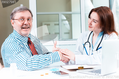 Image of The patient and his doctor in medical office
