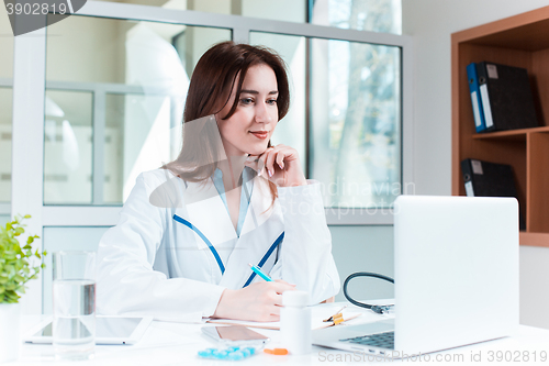 Image of Woman doctor sitting at the table