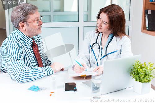 Image of The patient and his doctor in medical office