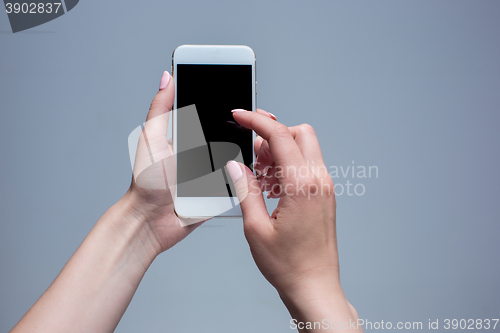 Image of Closeup shot of a woman typing on mobile phone 