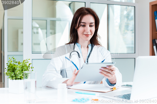 Image of Woman doctor sitting at the table