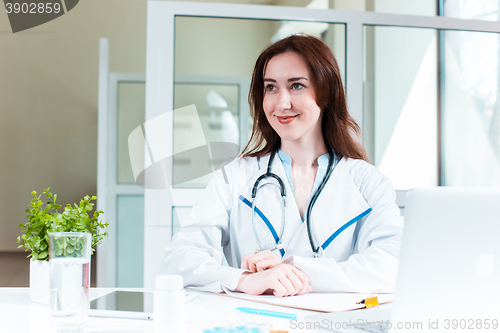 Image of Woman doctor sitting at the table