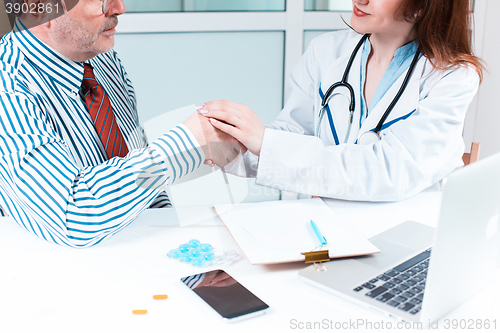 Image of The patient and his doctor in medical office