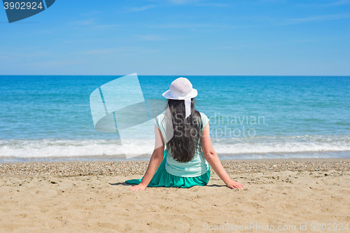 Image of Brunette with long hair turned away