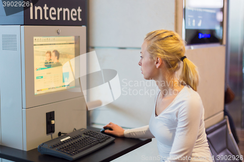 Image of Woman public internet access point on airport.