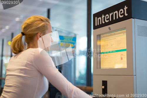 Image of Woman public internet access point on airport.