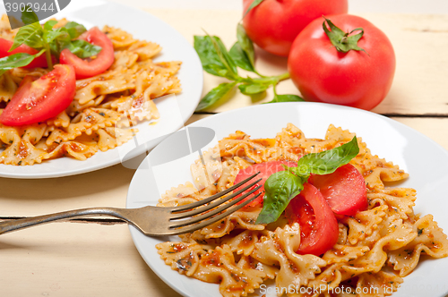 Image of Italian pasta farfalle butterfly bow-tie and tomato sauce