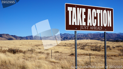 Image of Take Action Just Ahead brown road sign