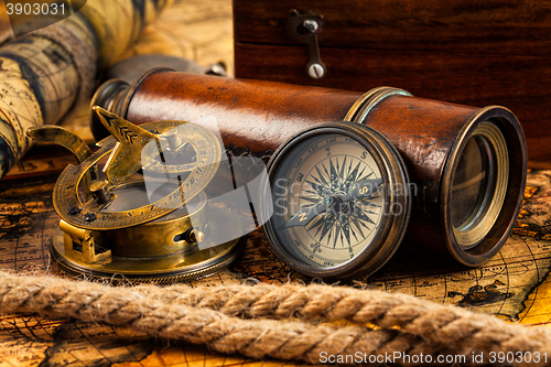 Image of Old vintage compass and navigation instruments on ancient map