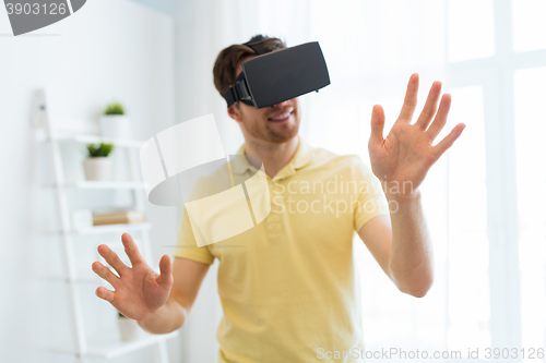 Image of young man in virtual reality headset or 3d glasses
