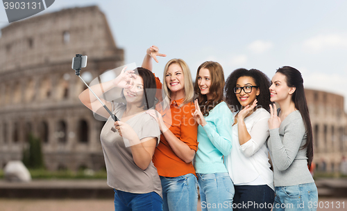 Image of group of happy women taking selfie over coliseum