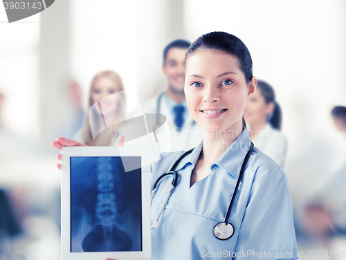 Image of female doctor with x-ray on tablet pc