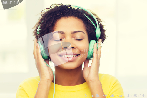 Image of happy woman with headphones listening to music