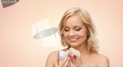 Image of happy woman with cream jar