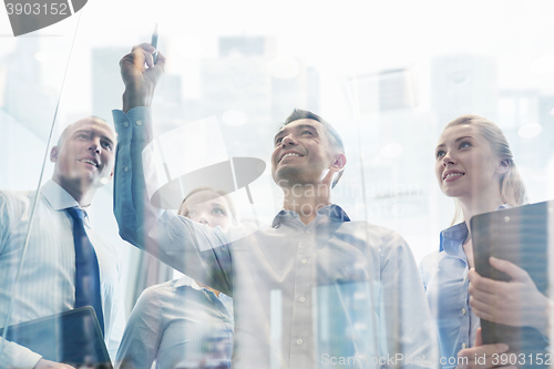 Image of smiling business people with marker and stickers