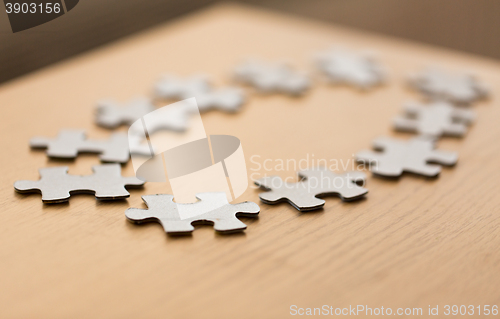 Image of close up of puzzle pieces on wooden surface