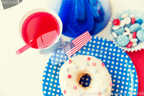 Image of donut with juice and candies on independence day