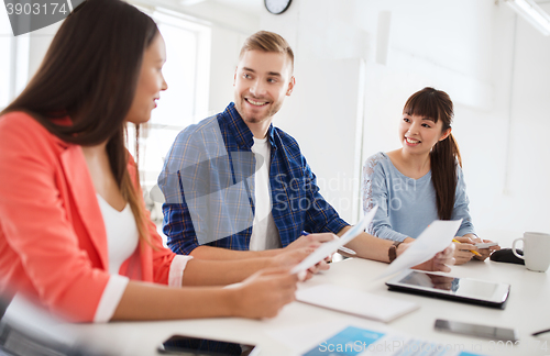 Image of happy creative team or students working at office