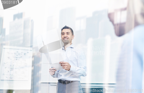 Image of smiling business people meeting in office