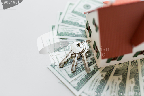 Image of close up of home model, money and house keys