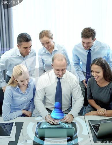 Image of smiling business people with laptop in office