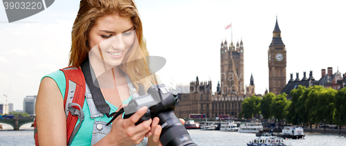 Image of woman with backpack and camera over london big ben