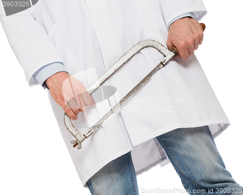 Image of Crazy doctor is holding a big saw in his hands