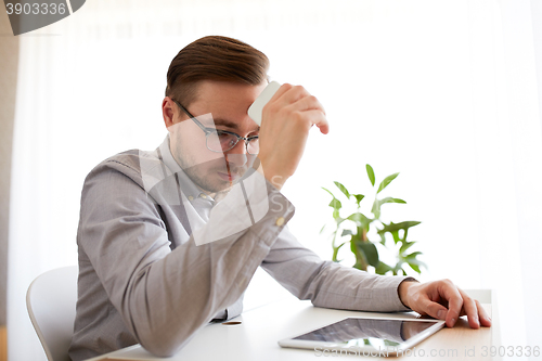 Image of businessman with smarphone at home office