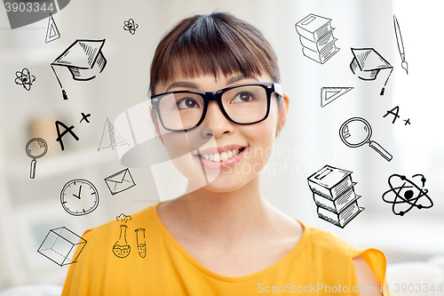 Image of happy asian young woman in glasses at home