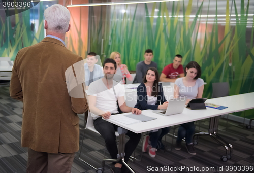 Image of teacher with a group of students in classroom