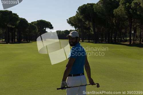 Image of golf player portrait from back