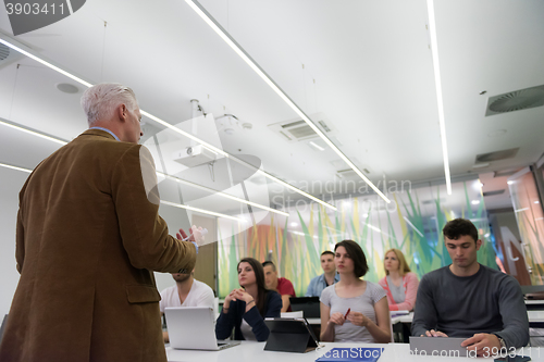 Image of teacher with a group of students in classroom