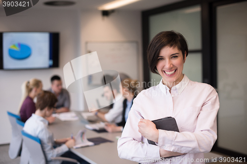 Image of hispanic businesswoman with tablet at meeting room