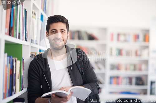 Image of portrait of student while reading book  in school library