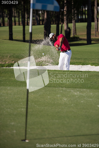 Image of golfer hitting a sand bunker shot