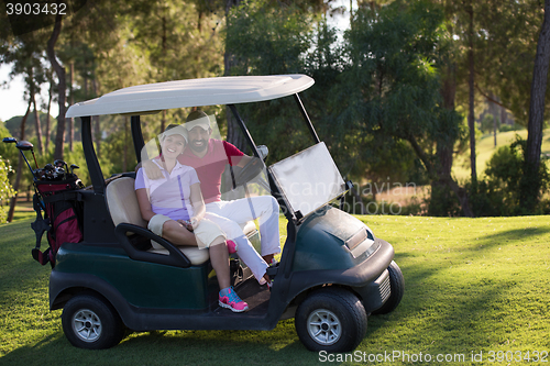 Image of couple in buggy on golf course